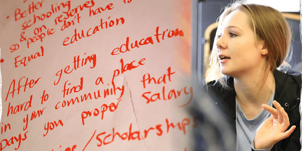 There are handwritten notes on a whiteboard or paper listing several educational issues and suggestions. Next to the notes, there is a person speaking or discussing something.